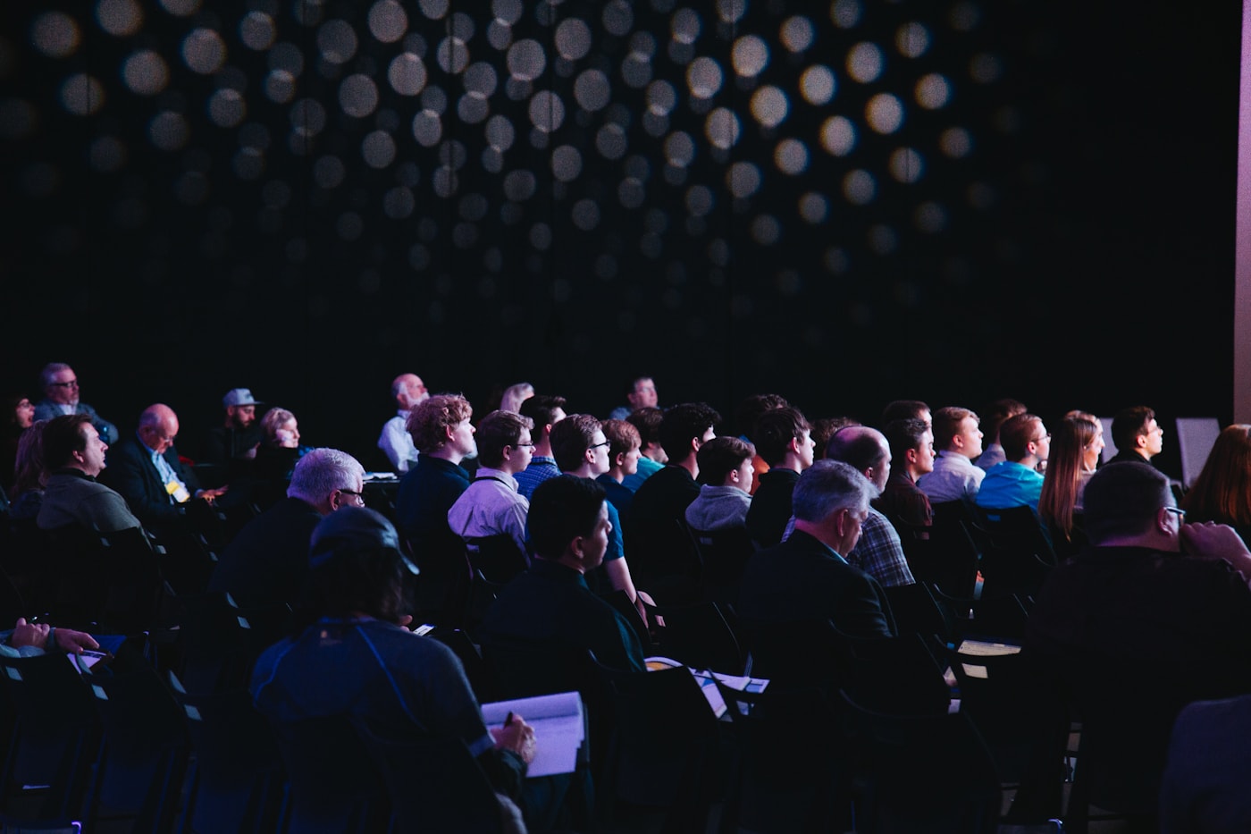 Conference room filled with attendees before a business event
